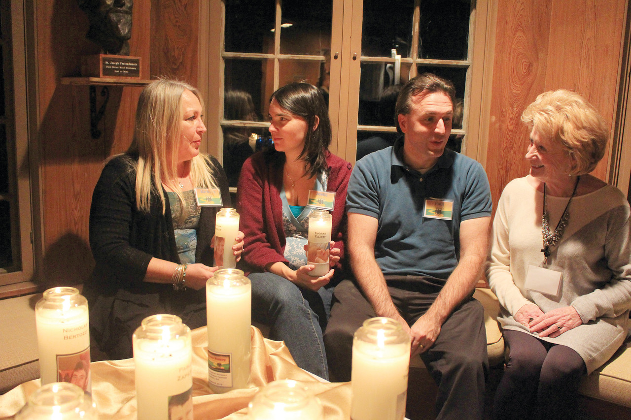 FINDING SOLACE: From left, Barbara Murray,  of Tiverton; Joelle and Paul Elliot, of Montreal; and Peggy Hassett, of Chelmsford, Mass., remember their loved ones who have passed as they participate in a session at Miramar Retreat Center in Duxbury, Mass., this past weekend. The Emmaus Ministry for Grieving Parents retreat will be offered at St. Theresa Church in Tiverton on Saturday, Nov. 21. All are invited to attend regardless of the age of the child lost or the amount of time passed.