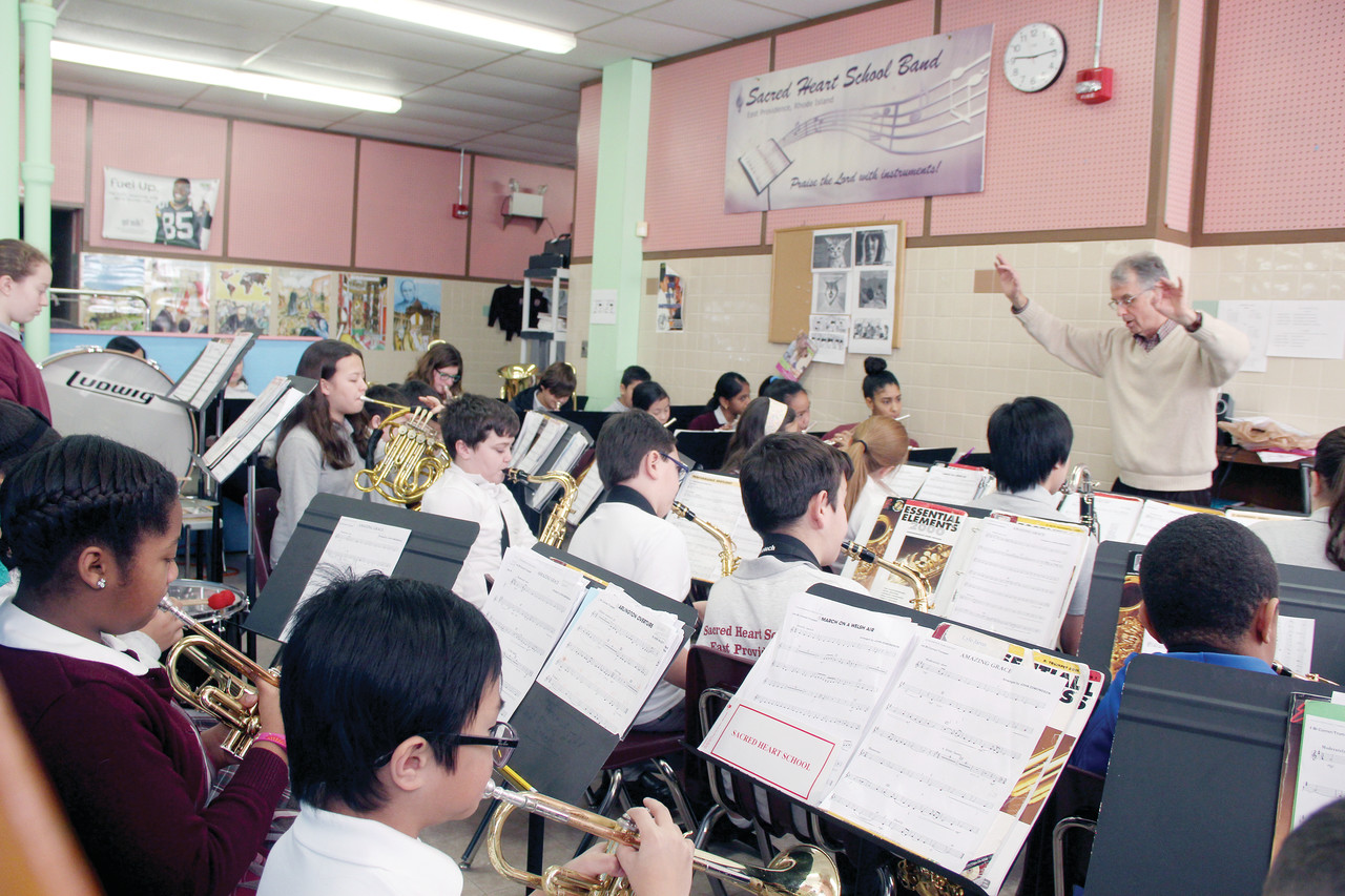 Sacred Heart School Band Director Philip Desrosiers and his students practice “Amazing Grace” for their Open House performance to be held on Sunday, January 31 — the kick off of Catholic Schools Week. Visit Rhode Island Catholic’s Facebook Page to see a clip of the Sacred Heart Band in action.