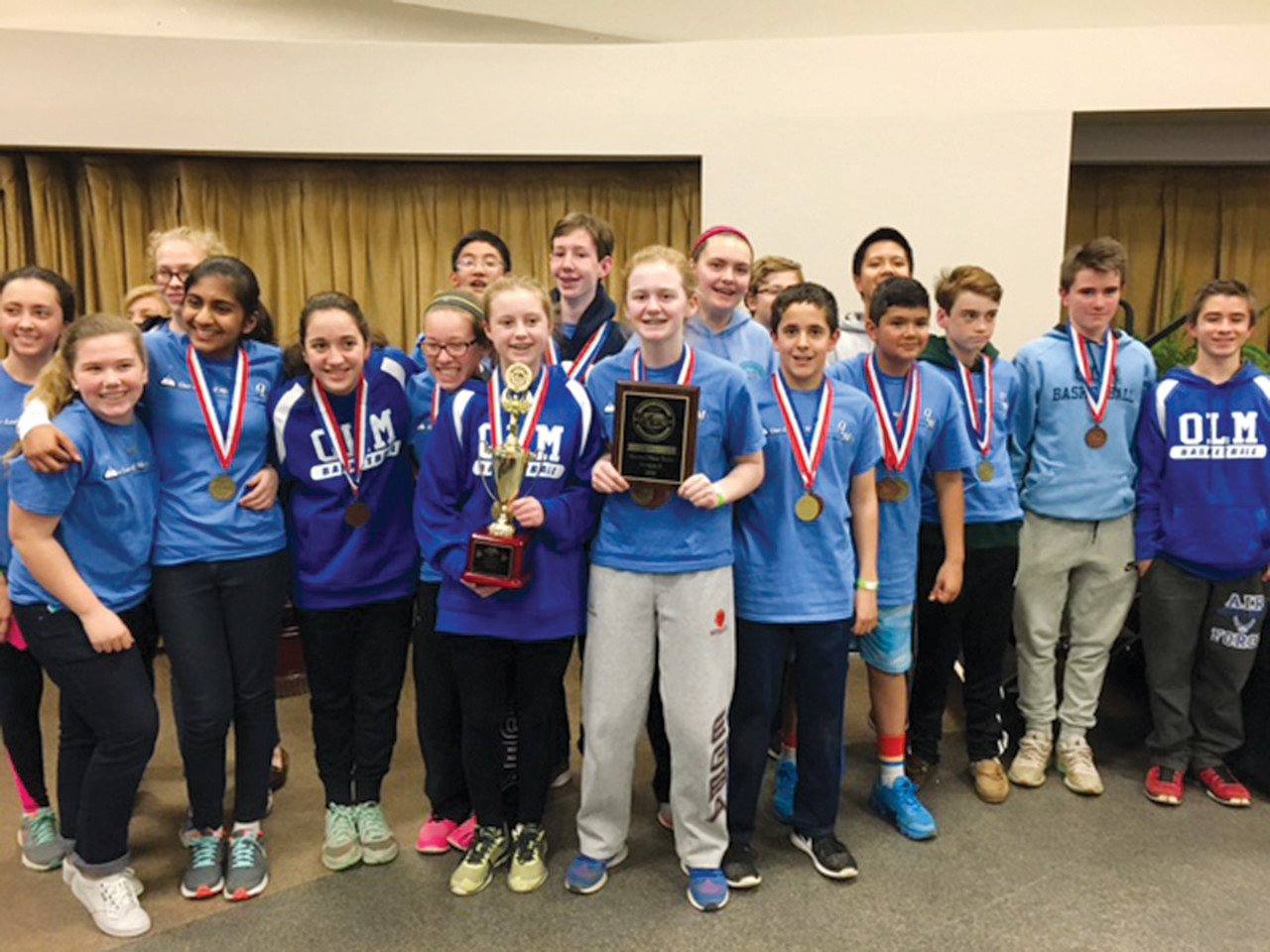 Members of OLM’s Science Olympiad team celebrate their second place trophy at the R.I. State Science Olympiad competition.