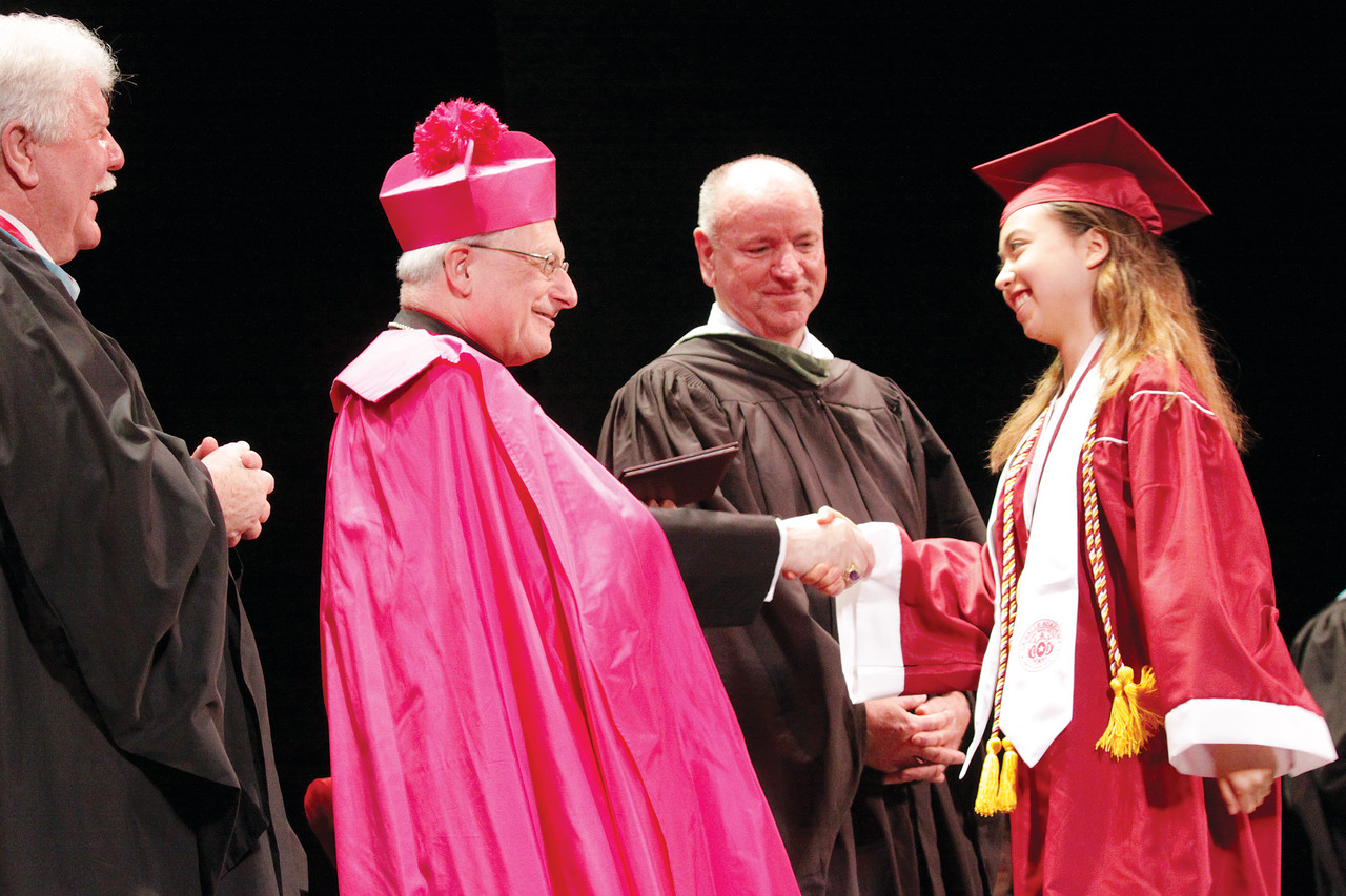 Allison Paul receives her diploma from Auxiliary Bishop Robert C. Evans, as La Salle President Brother Thomas Gerrow, F.S.C., left, and Principal Donald Kavanagh, right, look on.