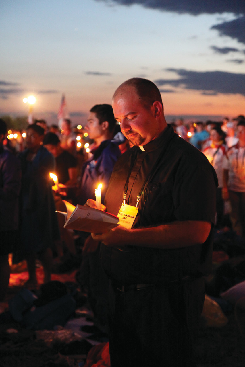 Father Scott Carpentier, assistant pastor at St. Augustine Church, Providence, joins diocesan youth and 1.5 million other Catholics in a candlelight prayer vigil led by Pope Francis on the final night of World Youth Day.
