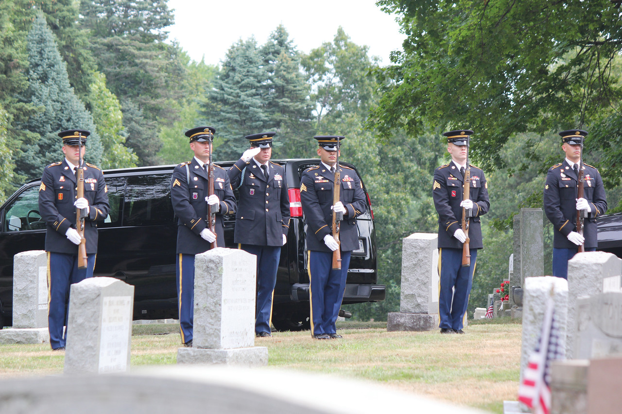 Members of the Army Honor Guard prepare to fire three volleys during the interment service at St. Francis Cemetery.