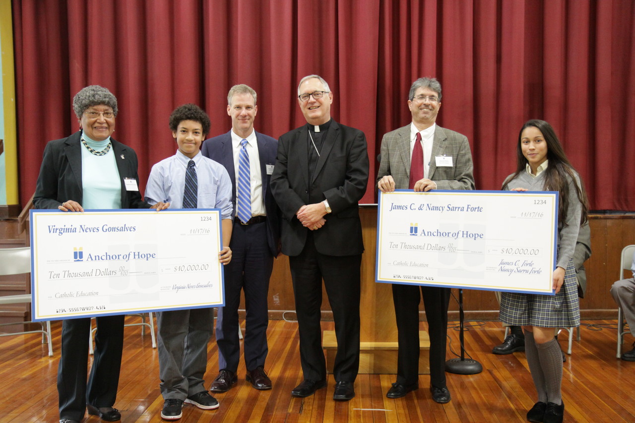 SUPPORTING CATHOLIC EDUCATION: Donors presented checks totally $20,000 to Bishop Thomas J. Tobin at the recent re-launch of the Anchor of Hope Fund, the diocesan financial assistance program for Catholic schools students who have demonstrated financial need. From left to right: donor Virginia Neves Gonsalves, St. Paul School student Anthony Sanchez, Superintendent Daniel J. Ferris, Bishop Thomas J. Tobin, donor James Forte and St. Paul School student Gabrielle Cepeda.
