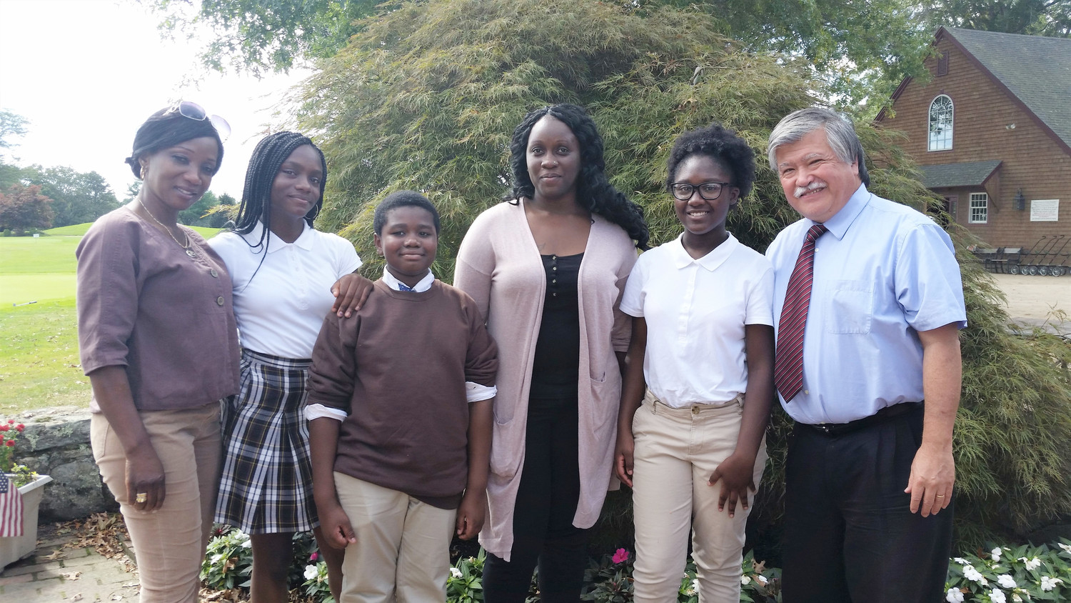 Bishop McVinney School Principal Louis Hebert, far right, with students and parents/alumni in September 2017.