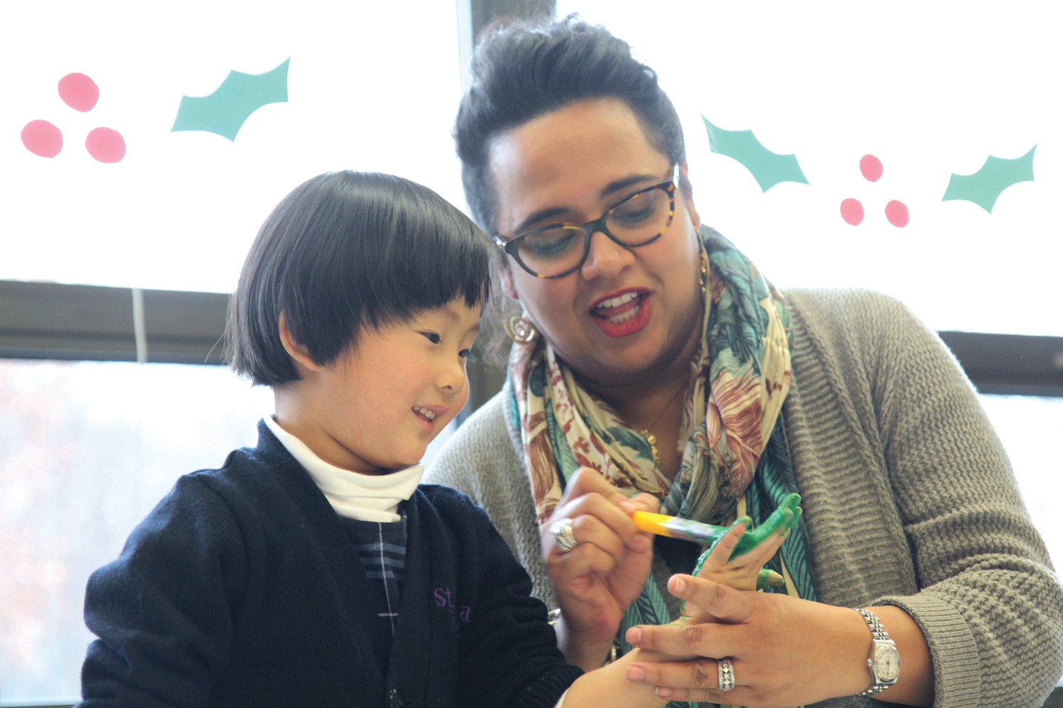 Volunteer Malin Marin-Bean works with St. Thomas Regional School student Claire Zhang during the after-school art club.