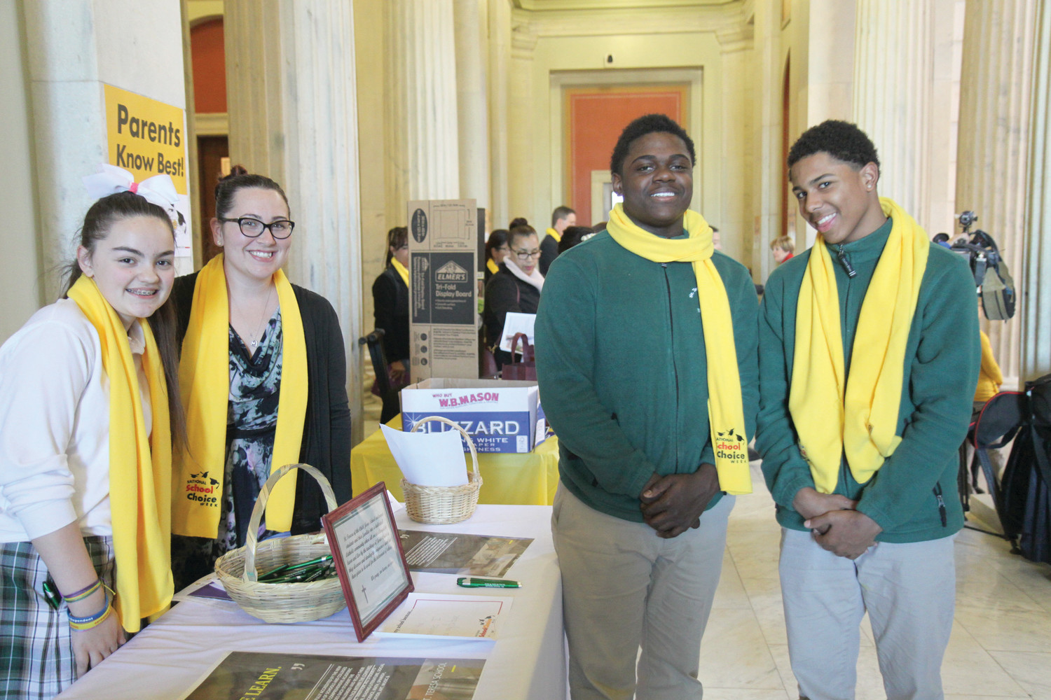 Students from St. Teresa School, Pawtucket, stand with their principal, Allison Amodie, to represent their school at the annual School Choice Rally at the Rhode Island State House. From left to right are sixth-grader Hannah Guevremont, Principal Amodie and eighth graders Elijah Osei and Henique Ross.