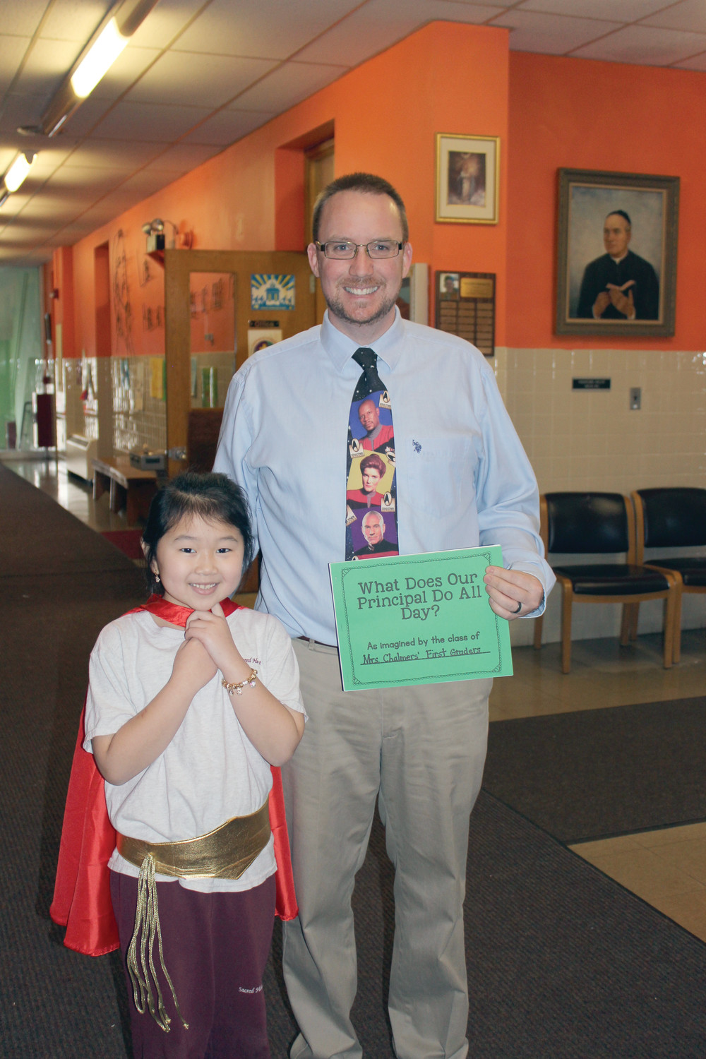 Rena Lieng is pictured presenting a special book to Mr. Woodmansee.