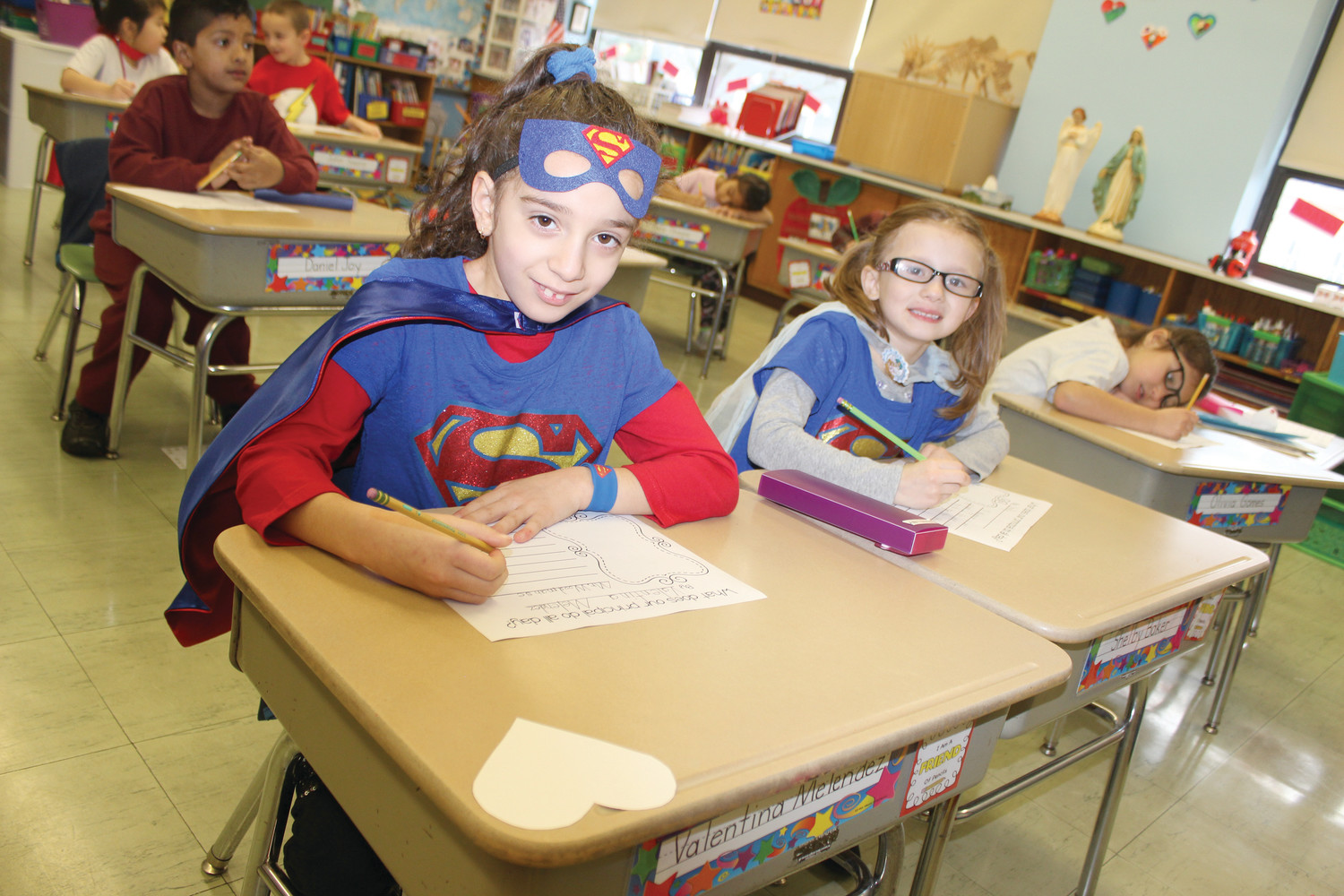 First graders Valentina Melendez and Shelby Baker dress as their favorite superheroes.