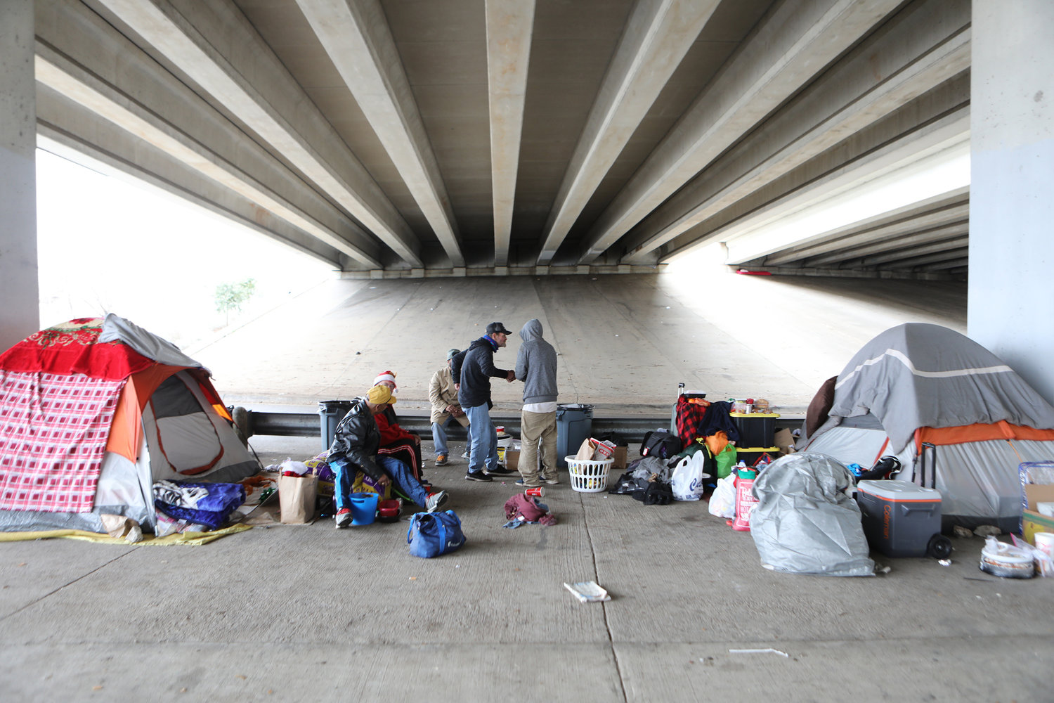 Homeless men are seen under a bridge on Christmas day in Austin, Texas. Catholic Charities staff are warning that the coronavirus pandemic presents a stark threat to the U.S. homeless population.