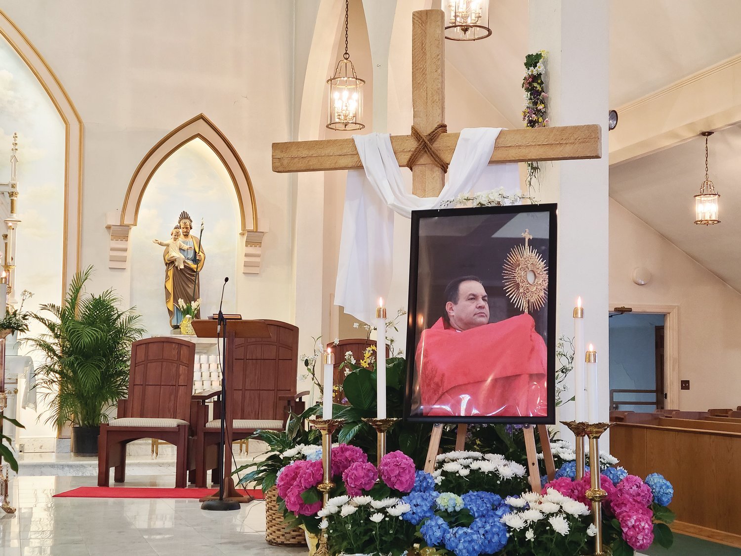 A framed photo of Father Marinaldo Batista in the sanctuary of St. Elizabeth Church in Bristol. Father Batista died from COVID-19 complications in his native Brazil on April 1, Holy Thursday.