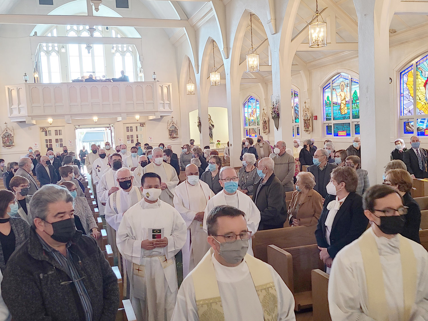 Priests process into St. Elizabeth Church for the Memorial Mass in honor of the church’s late pastor Father Marinaldo Batista, who died from COVID-19 complications in his native Brazil on April 1, Holy Thursday.