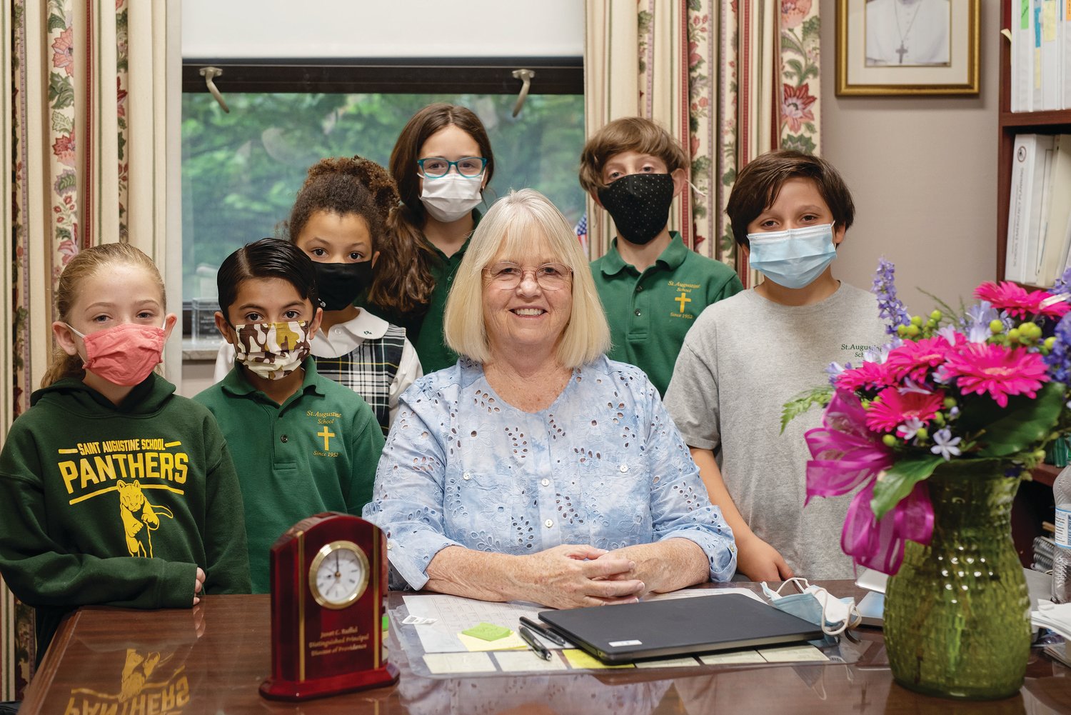 St. Augustine School Principal Janet Rufful smiles with students after being awarded with the 2020 Diocese of Providence Distinguished Principal of the Year Award. The award presentation had been previously postponed due to the COVID-19 pandemic.