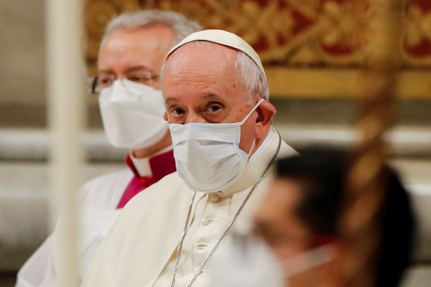Pope Francis wears a mask for protection from COVID-19 as he participates in an evening prayer service in St. Peter's Basilica at the Vatican Dec. 31, 2021. The traditional service on New Year's Eve gave thanks for the past year. (CNS photo/Remo Casilli, Reuters).