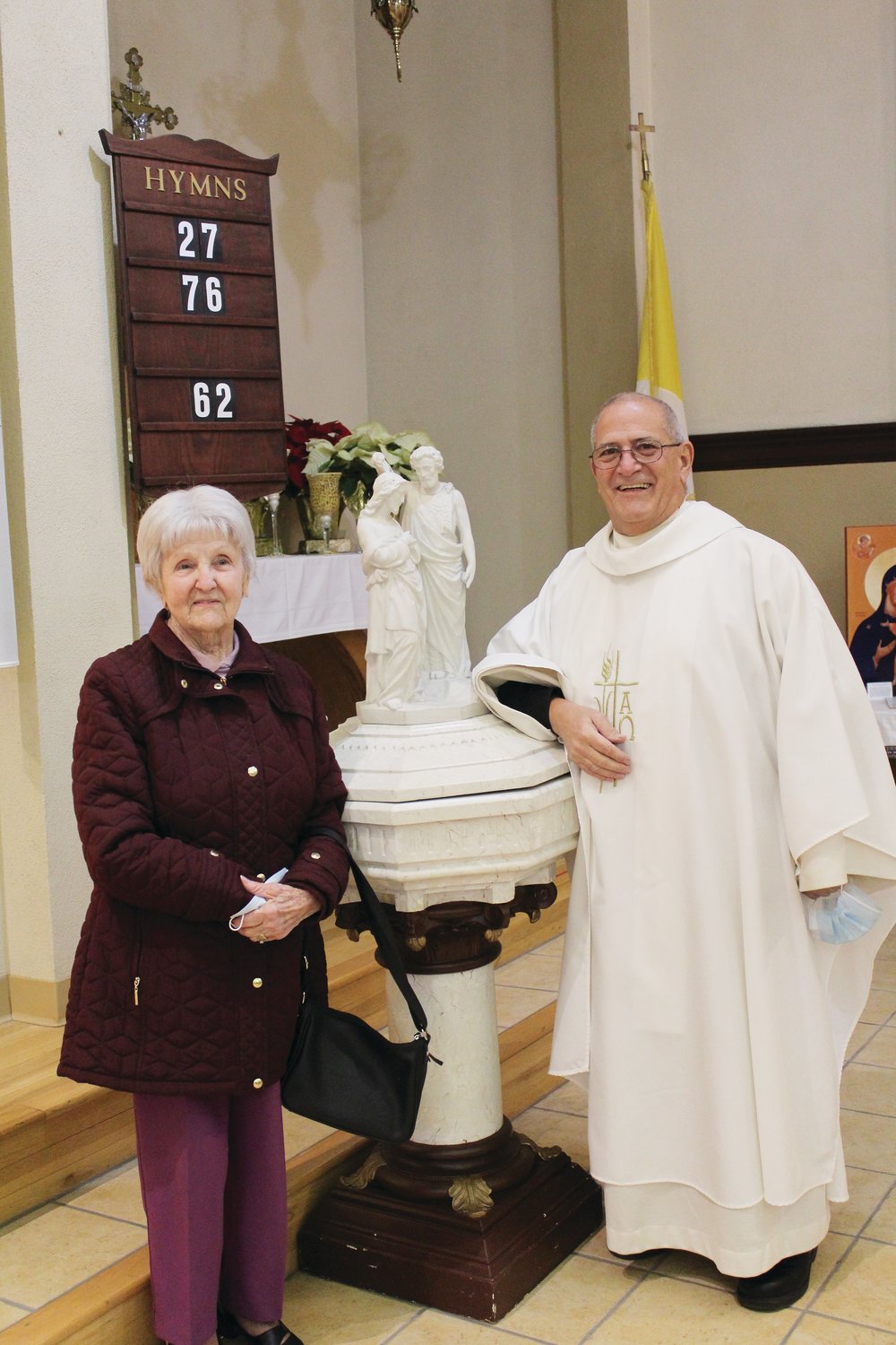 Marie Helen Jeannete LaFramboise smiles with Father Paul Lemoi, pastor of Our Lady of Good Counsel.