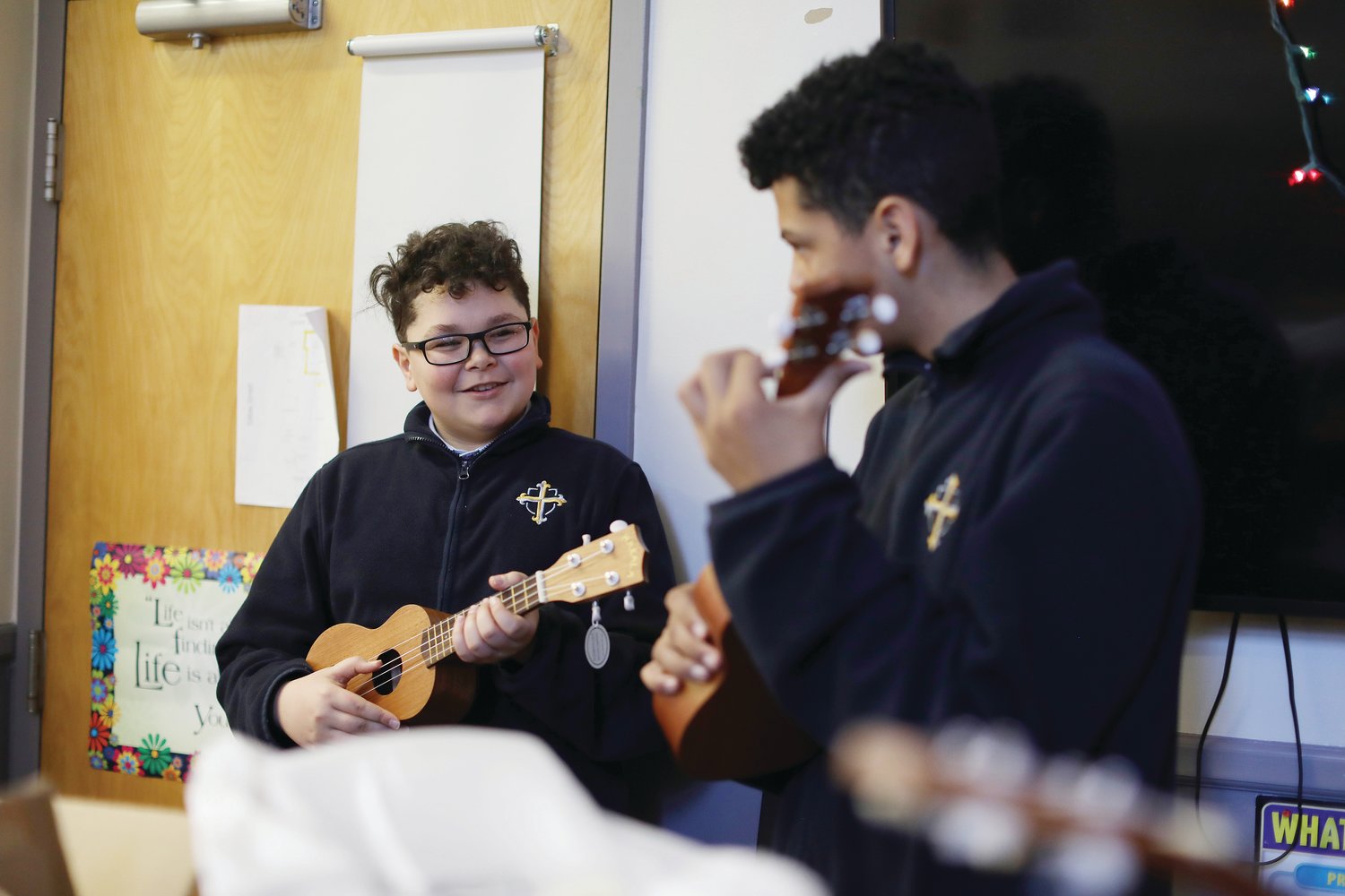 Students from St. Pius V and Sacred Heart schools enjoy their new ukuleles donated by McVinney Auditorium.
