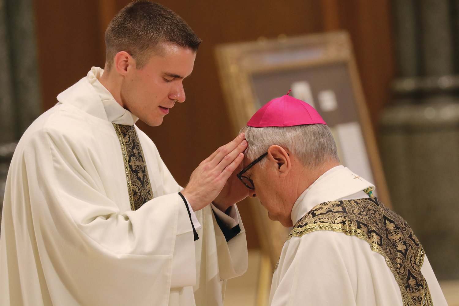 Father Gadoury confers a blessing upon Bishop Tobin.