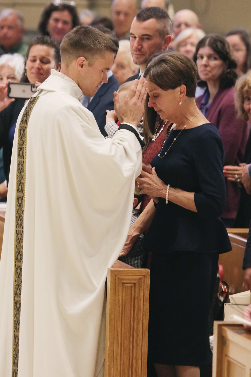 Father Mark Gadoury offers a blessing upon his mother, Cheryll.