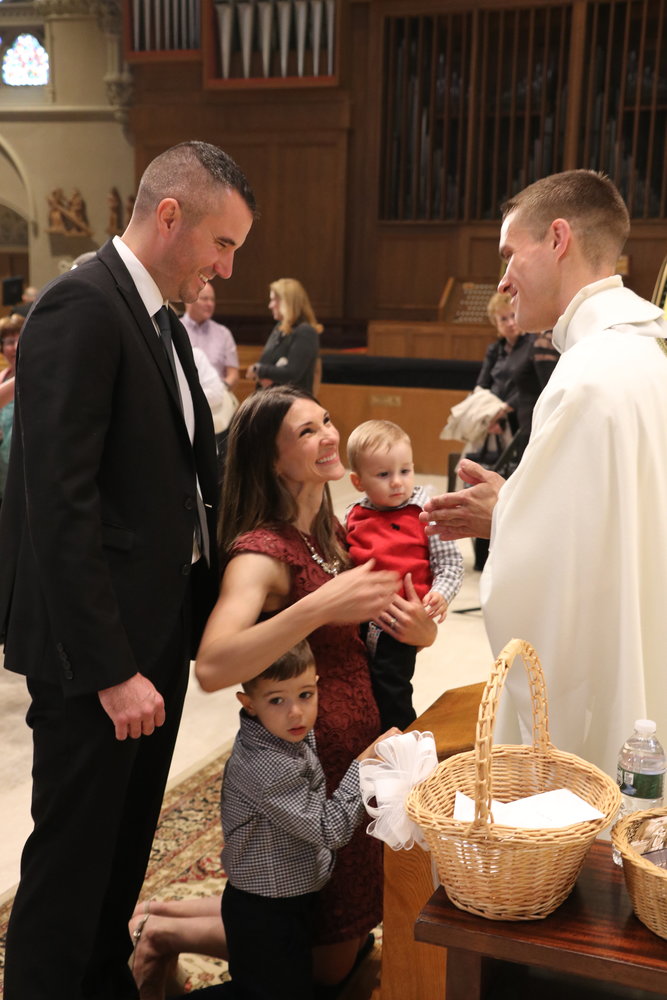 Following the Mass, Father Gadoury conferred individual blessings upon those gathered, including his sister Rachel Hursthouse, her husband Tom and their children, center.