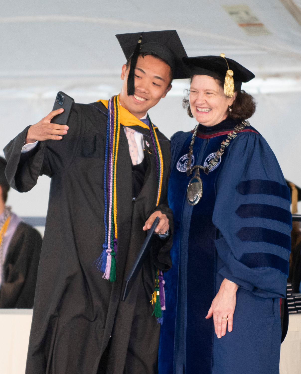 Salve Regina University graduate Yoshiki Hoshinaga take a selfie with Dr. Kelli Armstrong after receiving his diploma commencement exercises Sunday, May 8, 2022.