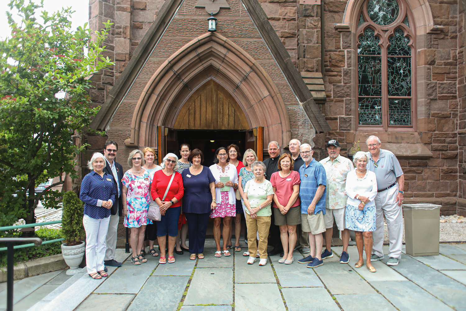Since June, more than 300 new faces have been stopping by the historic St. Mary’s Church in Newport each week. This increased traffic is all thanks to the parish’s new Ambassadors Club. Thanks to the presence of passionate and dedicated volunteers, these ambassadors of the faith help to keep their church doors open throughout the week for tourists, curious locals and other parishioners by spending an hour or two each day greeting visitors who come to pray and to learn more about this holy and historic landmark in the City by the Sea.