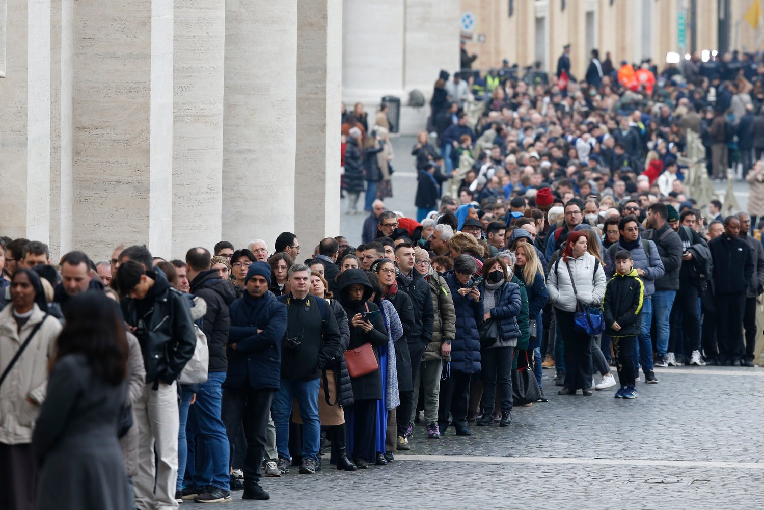 People wait in line to enter St. Peter's Basilica to view the body of Pope Benedict XVI at the Vatican Jan. 2, 2023.