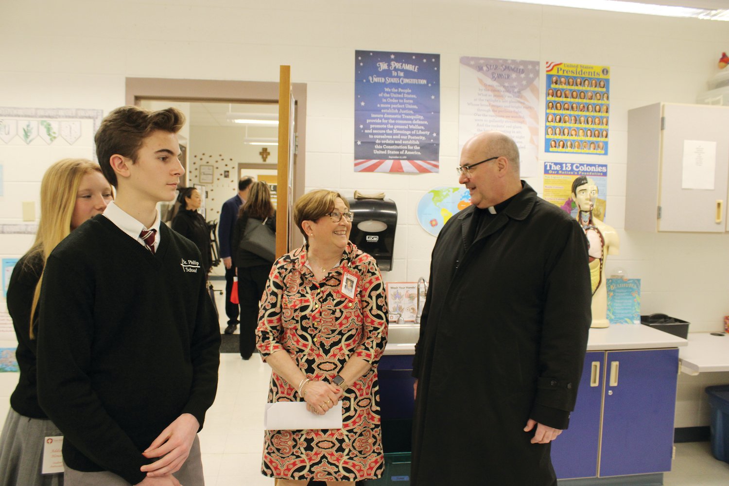 Coadjutor Bishop Richard Henning tours the parish school.