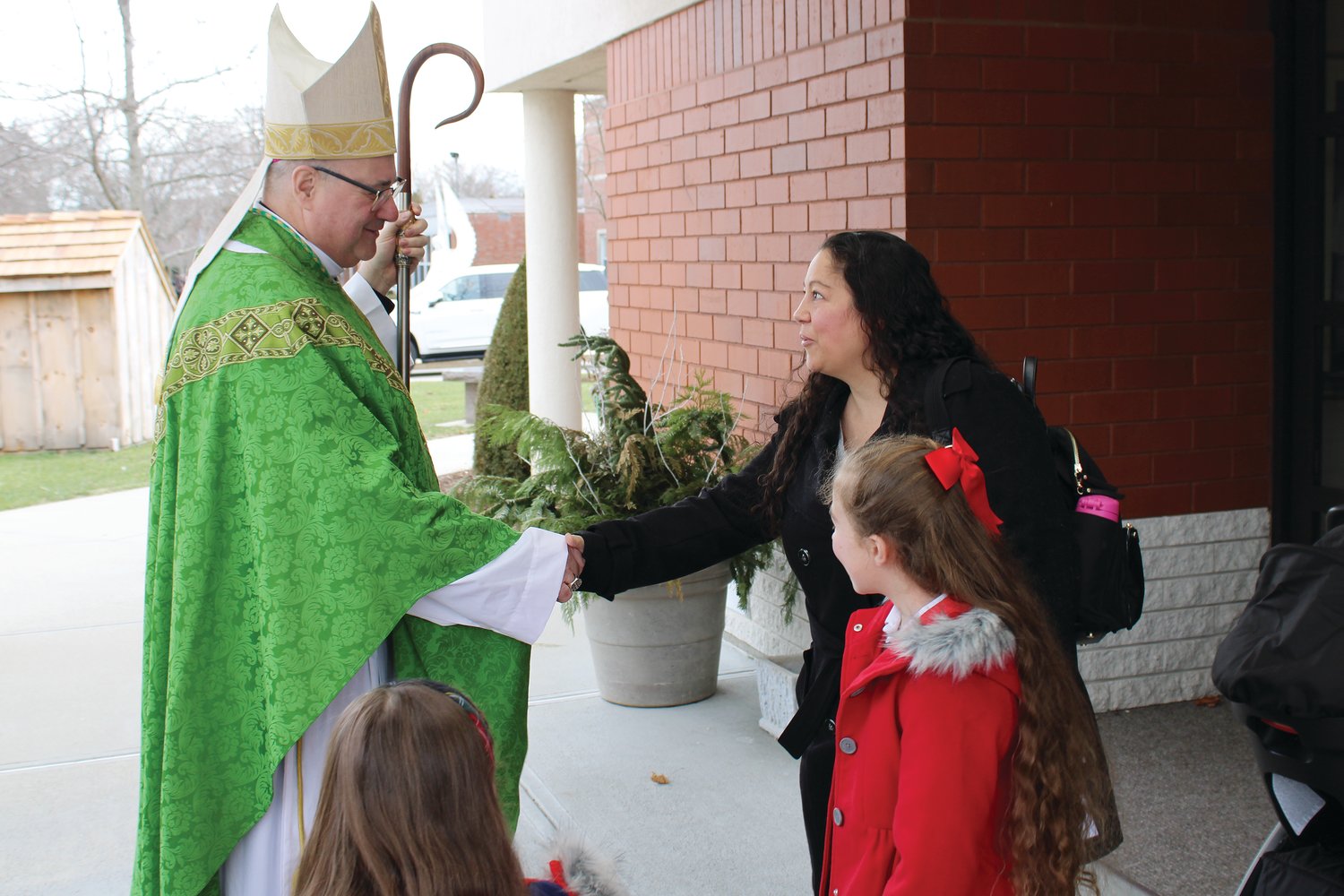 Coadjutor Bishop Richard Henning greeted families after a Catholic Schools Week Mass on Jan. 29 at St. Philip Church.