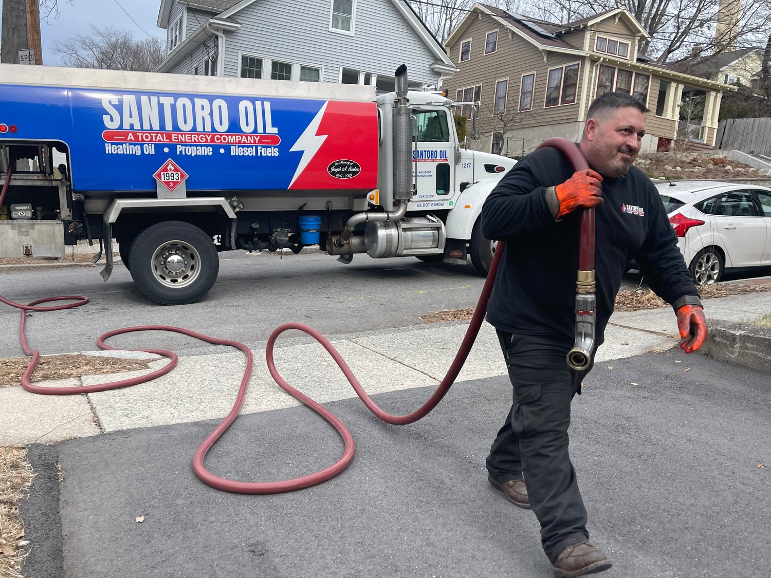 John Shadoian, a driver for Santoro Oil Company, prepares to fill a fuel tank during a stop in Providence. John Santoro, CEO/owner of the Santoro Family of Companies, which includes Santoro Oil, which has been in business since 1952, made a $50,000 donation this year to Keep the Heat On.