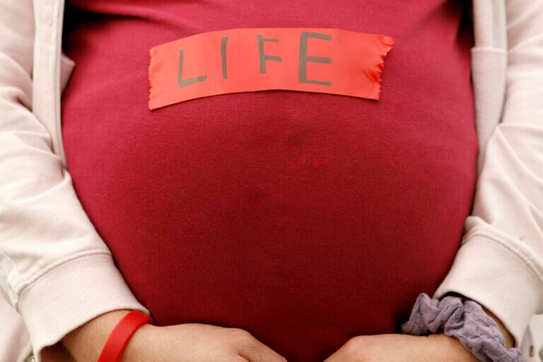 A pregnant pro-life demonstrator is pictured in a file photo outside the Supreme Court in Washington. National pro-life leaders stress the importance of the proposed "Care for Her Act," which would provide support for women, specifically pregnant and parenting women. The U.S. House of Representatives in its current term has not yet taken up the bill, first introduced in 2021.