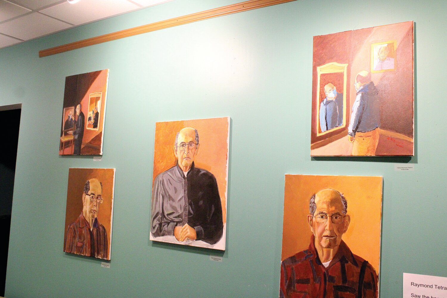Paintings, including these self-portraits above, by the late Father Raymond Tetrault, were recently displayed for the first time in a gallery exhibit.
