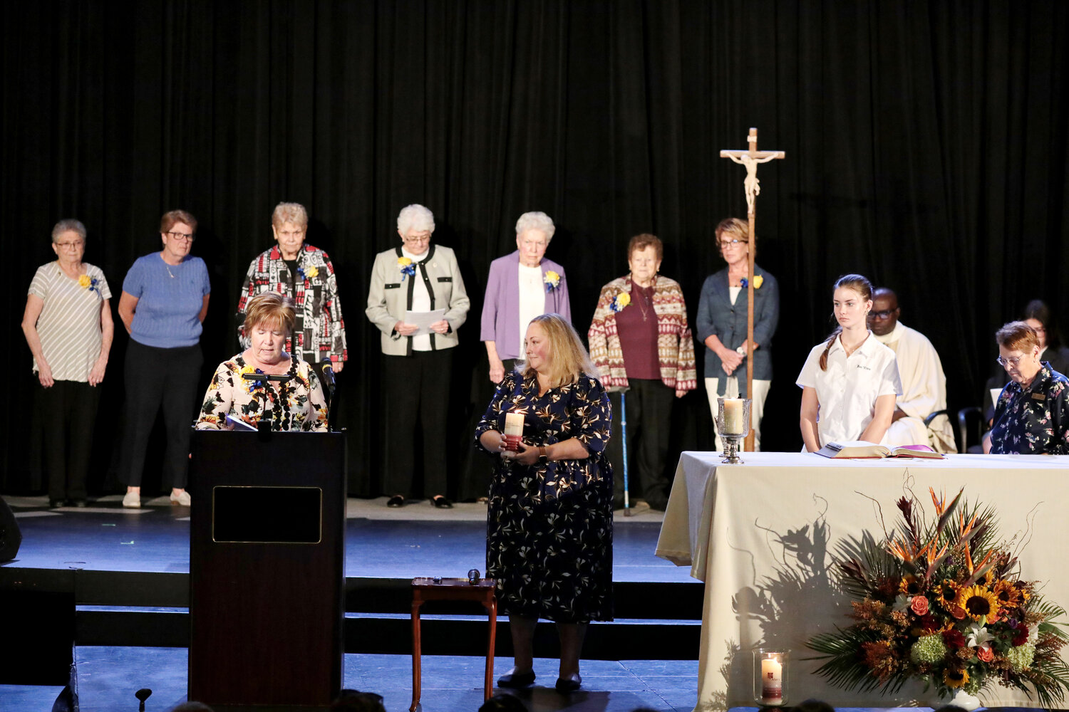 Amy Gravell, class of 1993, was installed as the fourth president of St. Mary Academy Bay View on Friday, Sept. 23, as past presidents and principals stand behind her on Mercy Hall stage to offer their prayerful support.