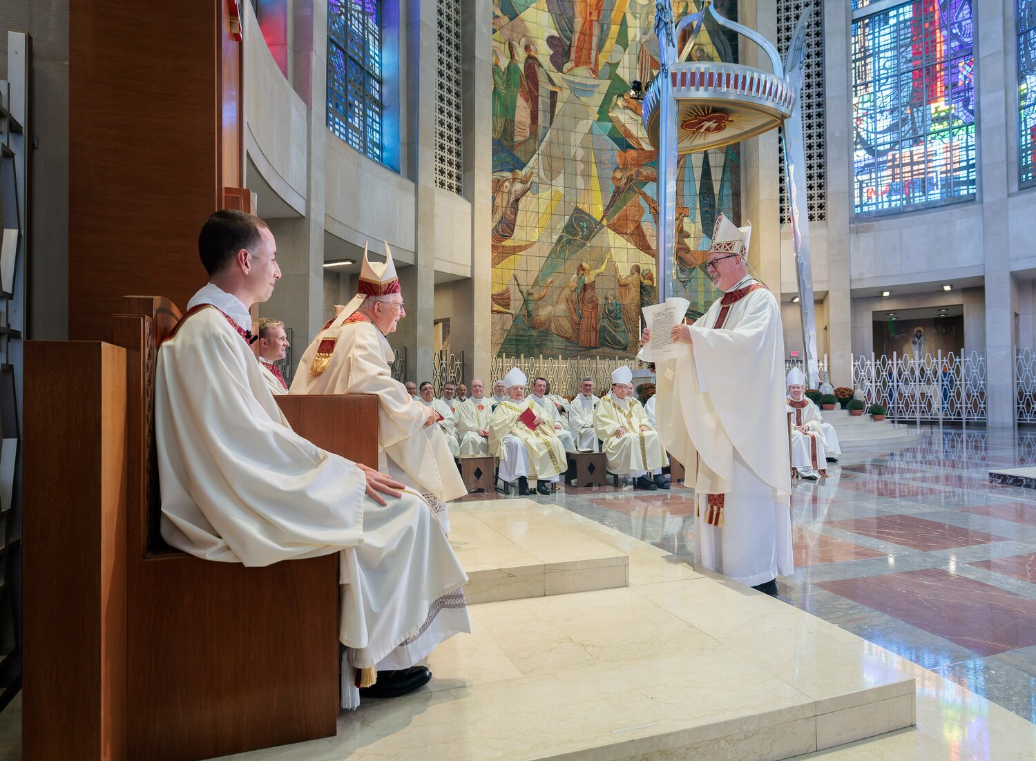 Coadjutor Archbishop Christopher J. Coyne shows the papal bull from Pope Francis to Archbishop Leonard P. Blair during a Mass of welcome at the Cathedral of St. Joseph in Hartford, Conn., Oct. 9, 2023. Archbishop Coyne, the former bishop of Burlington, Vt., will serve alongside Archbishop Blair and will succeed him automatically when he retires.