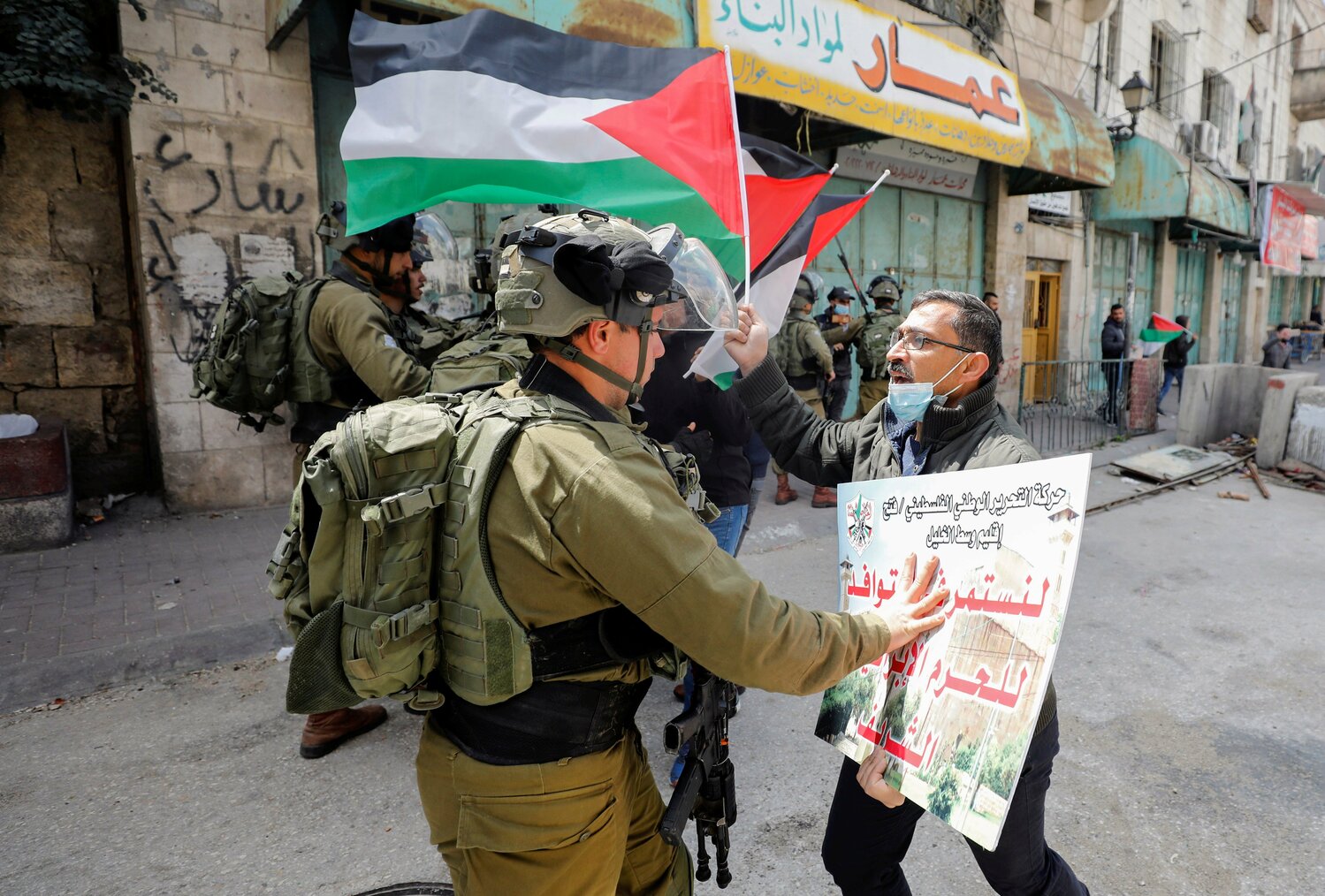 A Palestinian demonstrator argues with an Israeli soldier during a protest in this file photo from March 31, 2021.