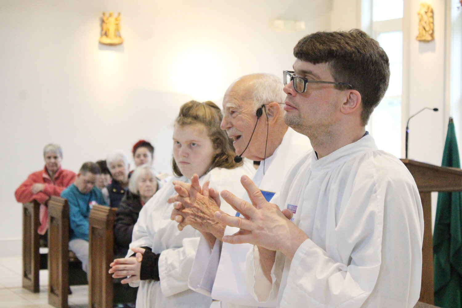 Rachel Gederman and Stephen McNamara assist Msgr. Gerard Sabourin during the annual SPRED Mass at St. Kateri Tekakwitha Catholic Church, Exeter. The Special Religious Education (SPRED) Office of the Diocese of Providence helps parishes in Rhode Island better serve those parishioners with intellectual and developmental disabilities. SPRED responds to the needs of individuals on the Autism spectrum, Down syndrome, cerebral palsy and seizure disorders, as well as people with other diagnoses.
