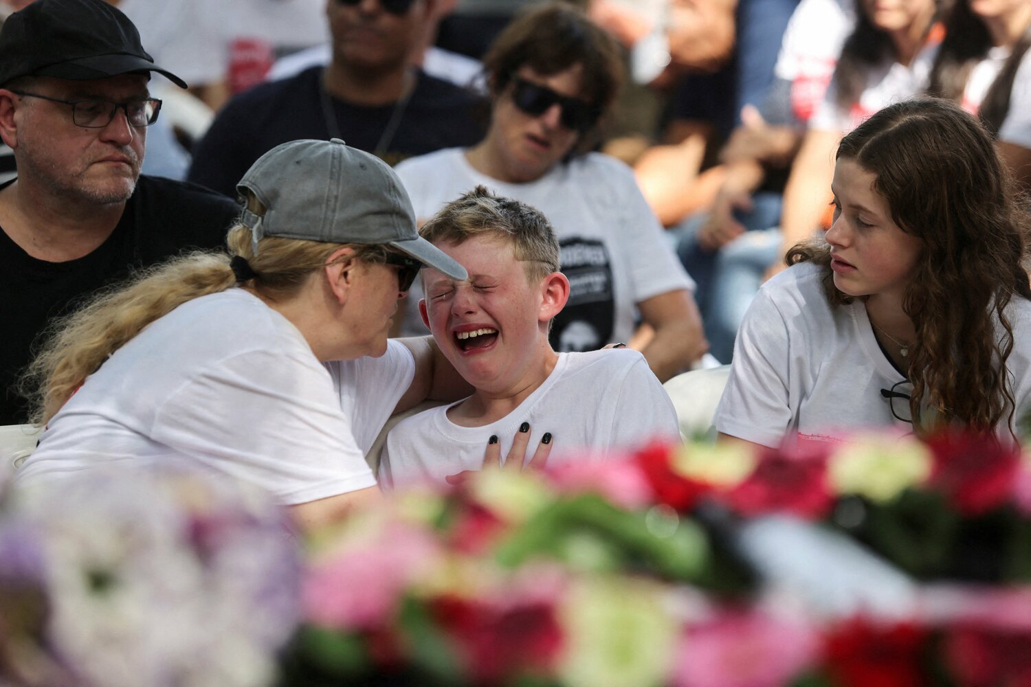 Shahar, 9, the brother of Maayan Idan, 18, who was killed following a deadly infiltration by Hamas gunmen in kibbutz Nahal Oz, and son of Tzahi who was kidnapped to the Gaza Strip, reacts during Maayan's funeral in kibbutz Einat, Israel, Oct. 22, 2023