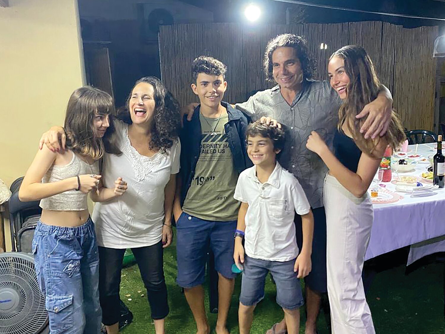 In the family photo Hadas and Ofer Kalderon gather for a family photo in Kibbutz Nir Oz with their four children, from left, Sahar, now 16; Rotem, 19; Erez, 12; and Gaia, 21.