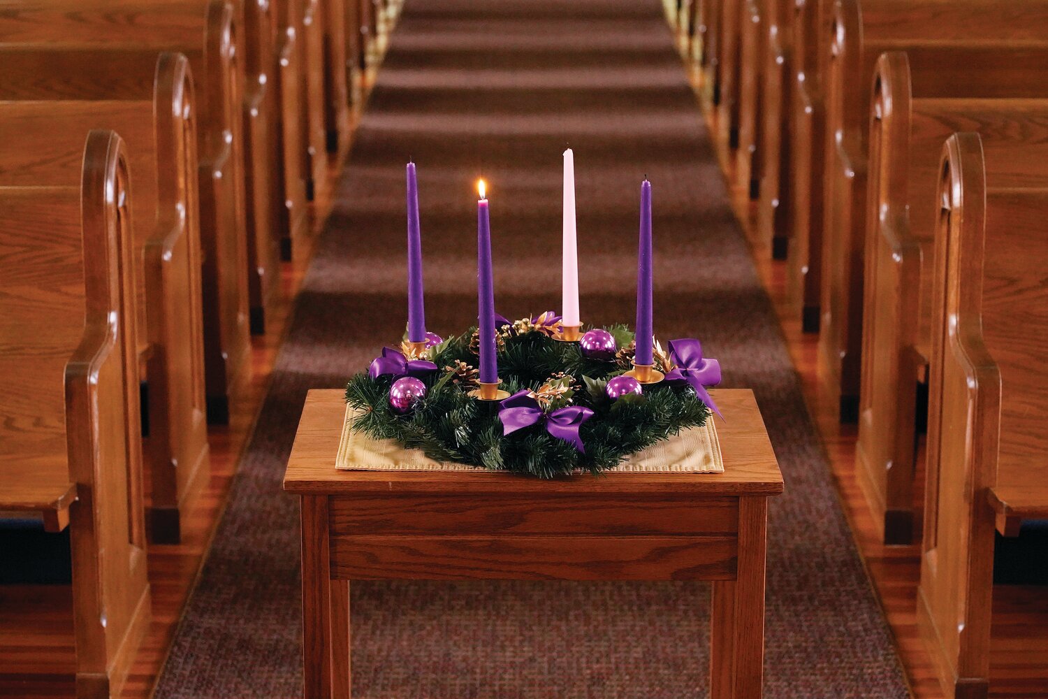 A lit candle is seen on a wreath for the first Sunday of Advent in this illustration photo. The wreath, which holds four candles, is a main symbol of the Advent season, with a new candle lit each Sunday before Christmas.