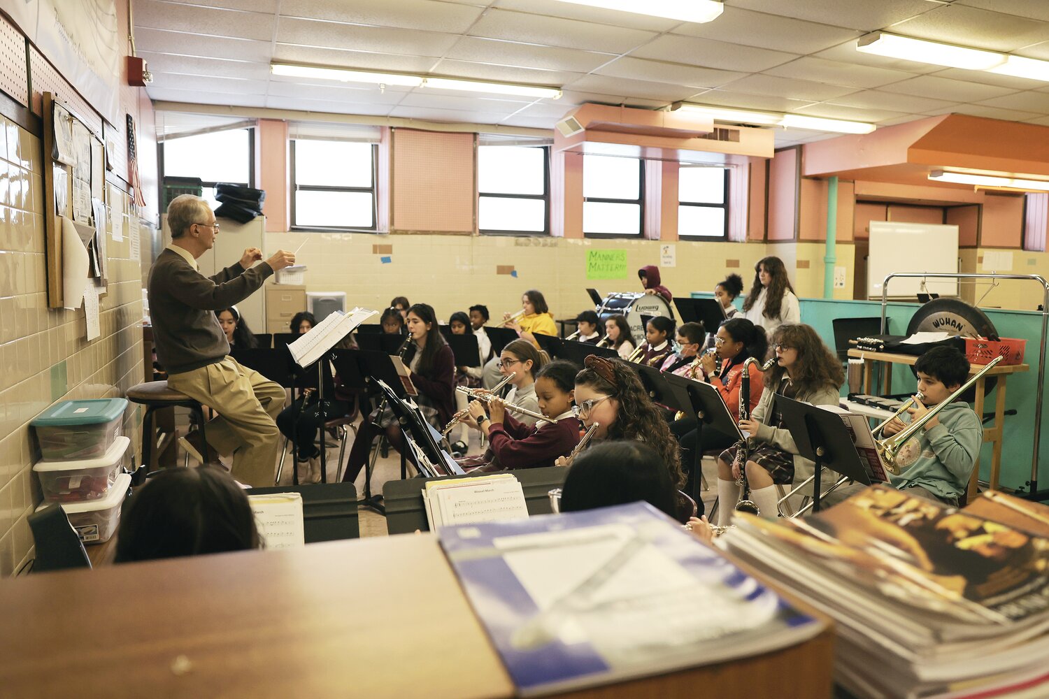 Phil Desrosiers, music teacher and bandleader at Sacred Heart School in East Providence leads the young musicians during a recent practice.