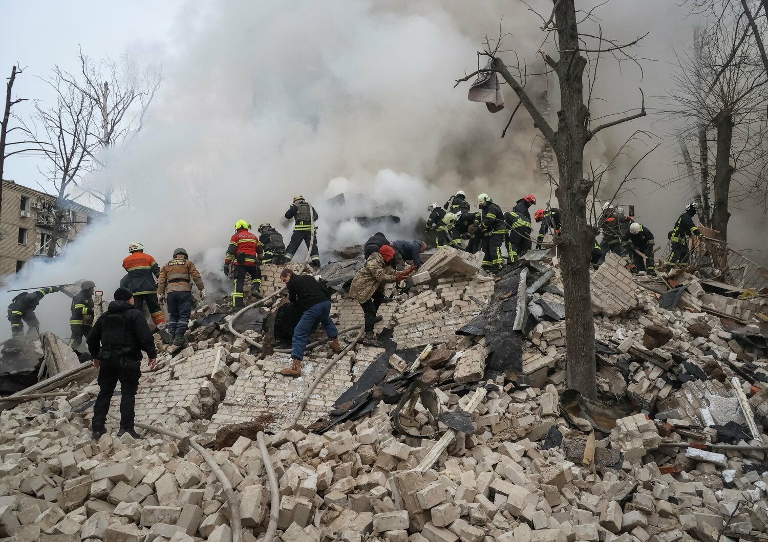Rescuers work at a site of a residential building heavily damaged in Kharkiv, Ukraine, Jan. 23, 2024, following a Russian missile attack.