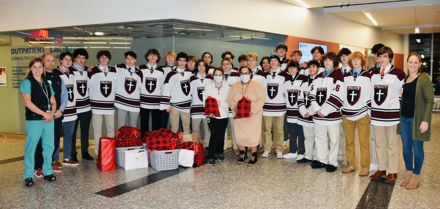 The entire Prout School hockey team visits the NICU on Dec. 23, 2023.