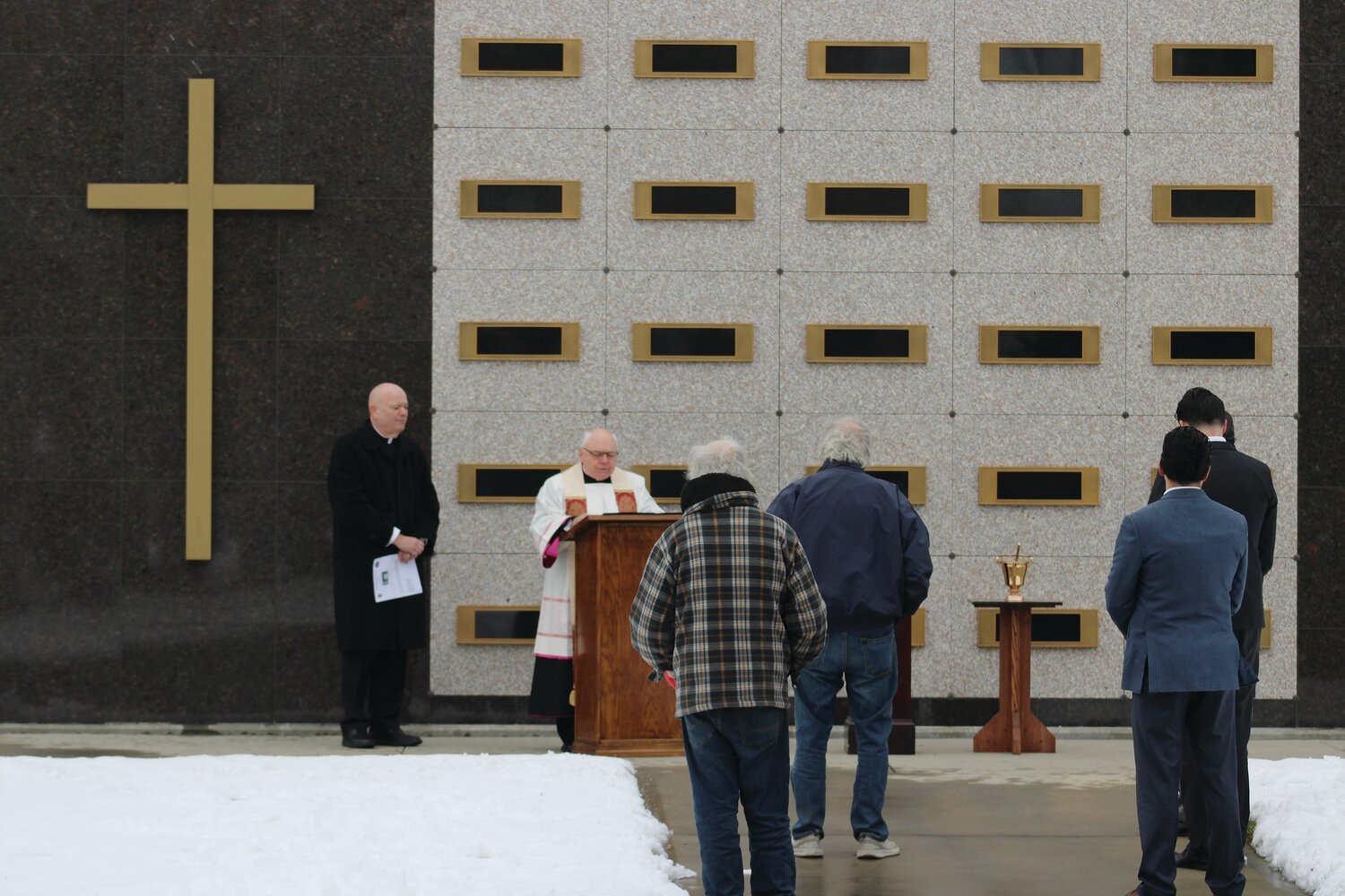 Reverend Msgr. Raymond B. Bastia and Father William J. Ledoux lead a dedication service for the Mausoleum of the Holy Cross at St. Ann’s Cemetery, Cranston.